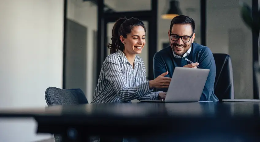 Man and Woman Reviewing Laptop